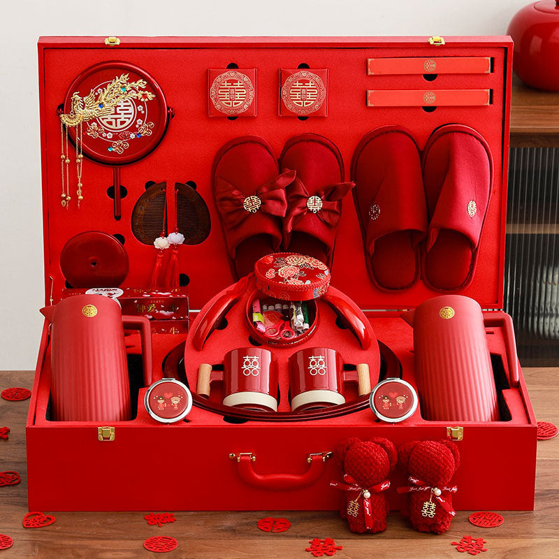 Red gift set with slippers, containers, and other items in a decorative box.